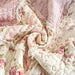 Close-up of DaDalogy Cotton Patchwork Throw Blanket in floral design with blush pink and cream ruffles, showcasing vintage charm.