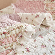 DaDalogy Cotton Patchwork Throw Blanket featuring floral prints, ruffles, and pastel shades, perfect for shabby chic decor.