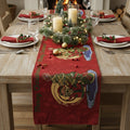 Dining table set for Christmas with a red table runner, candles, and decorative items.