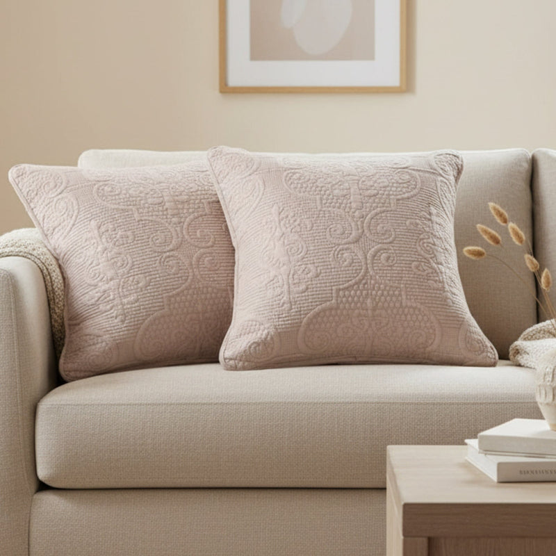 Beige sofa with textured pillows in a living room setting