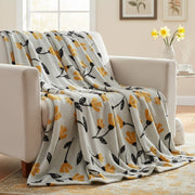 tulip Floral patterned blanket draped over a chair in a living room.