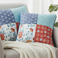 Colorful patchwork  18x18 throw pillows on a sofa with a white blanket