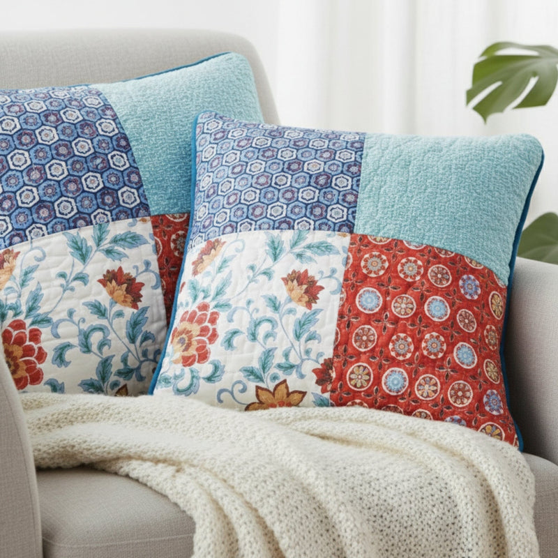 Colorful patchwork  18x18 throw pillows on a sofa with a white blanket