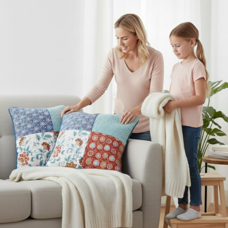 Woman and child arranging decorative pillows on a sofa in a bright living room.
