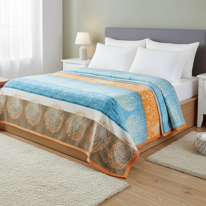 Bedroom with a bed featuring a blue and orange patterned blanket.