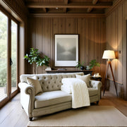 Cozy living room with a beige sofa, wooden walls, and a lamp with white sherpa and faux fur blanket warm and cozy and soft